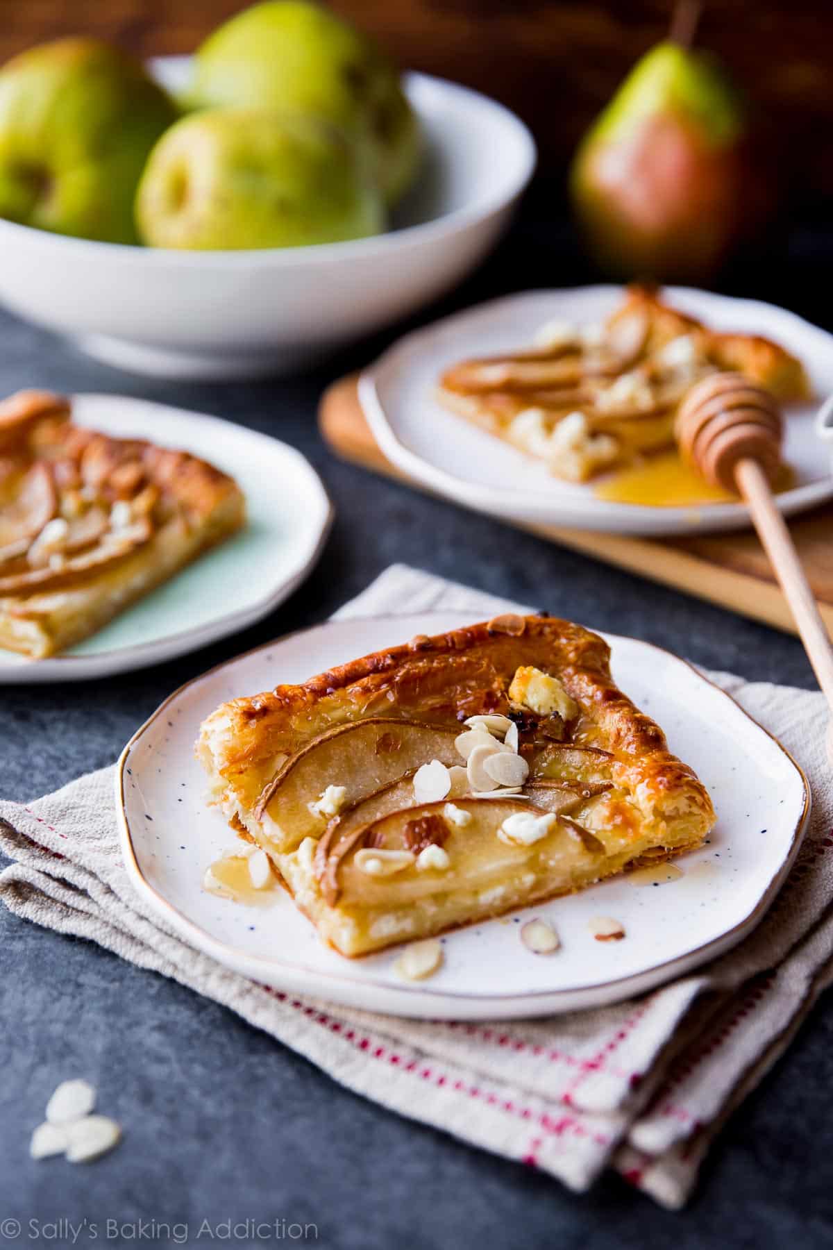 slices of honey pear tart on white plates