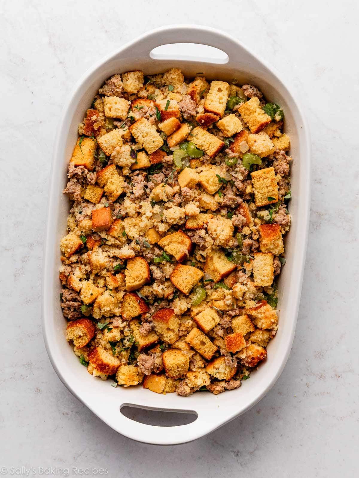 cornbread stuffing in white dish before baking.