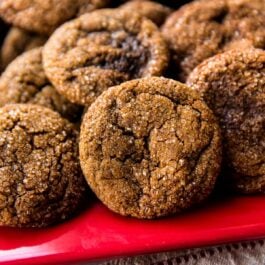crisp molasses cookies on a red serving tray