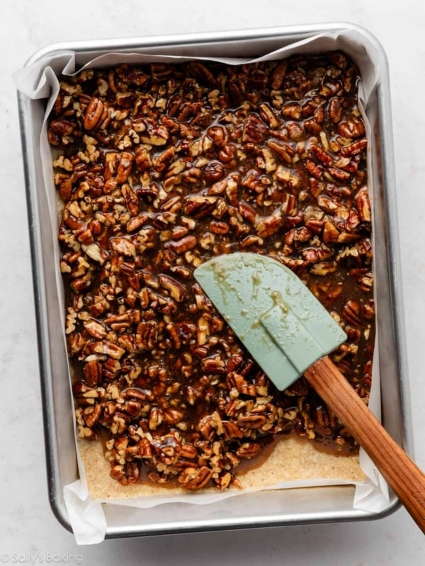 spreading topping over crust.