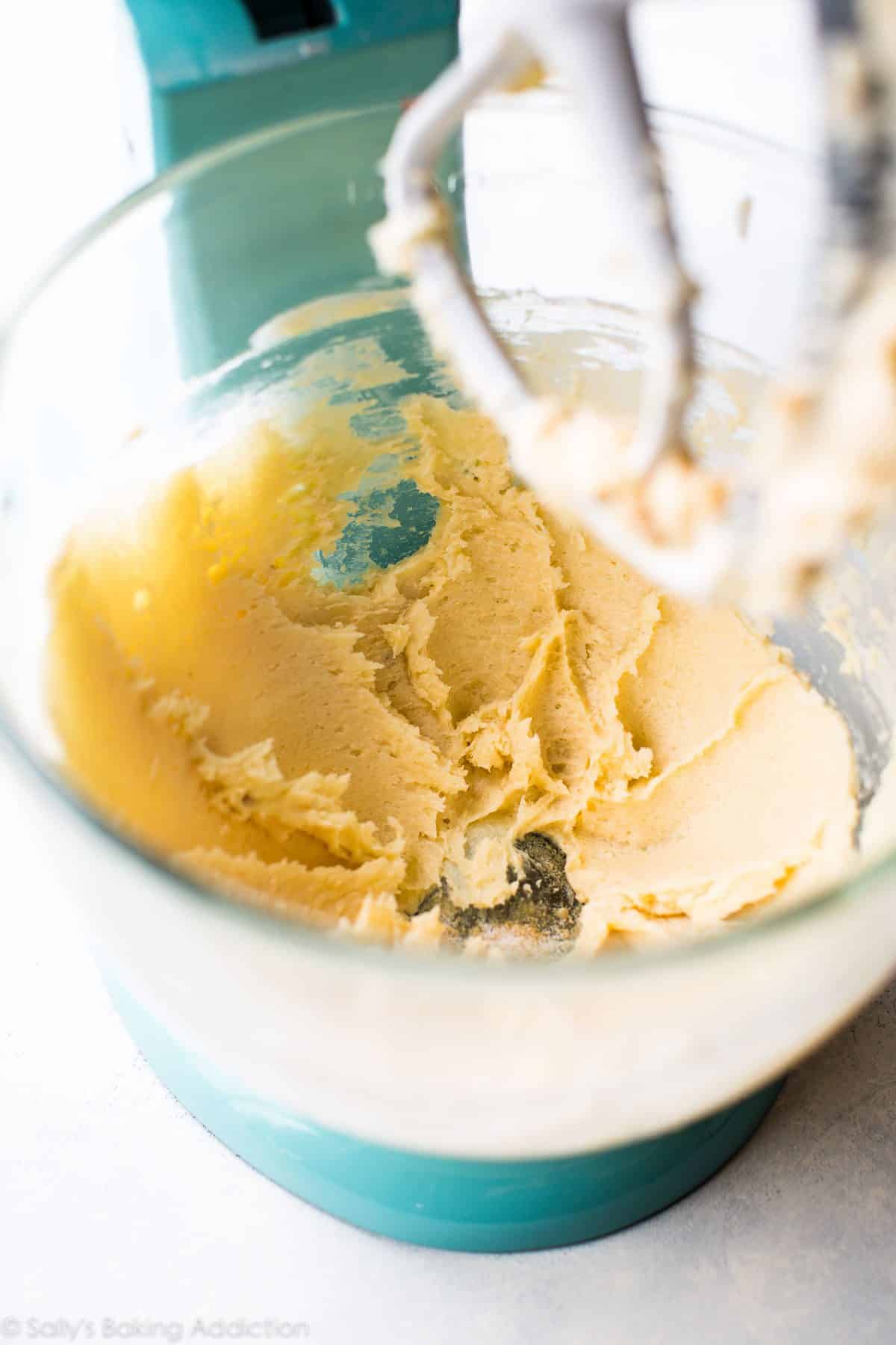 shortbread dough in a glass stand mixer bowl with the paddle attachment