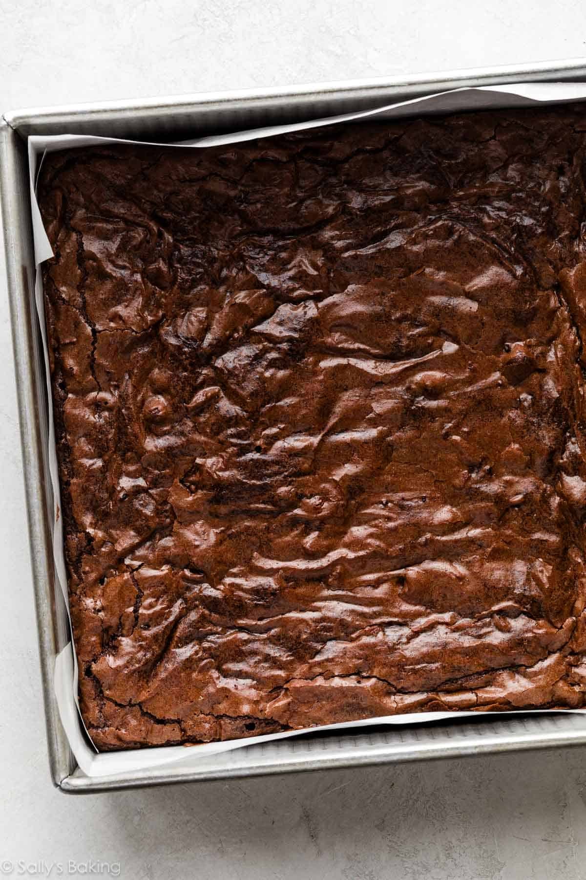 pan of brownies with shiny, crackly tops.