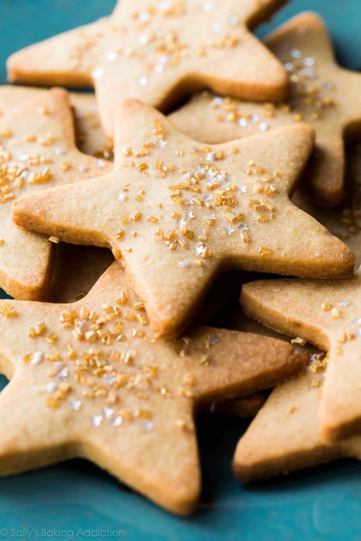 maple star sugar cookies with gold sprinkles on a blue plate