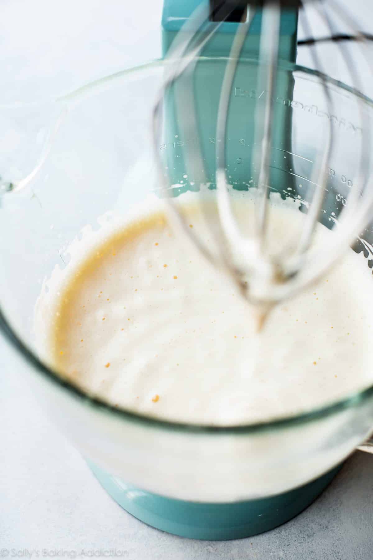 whipped eggs in a glass stand mixer bowl