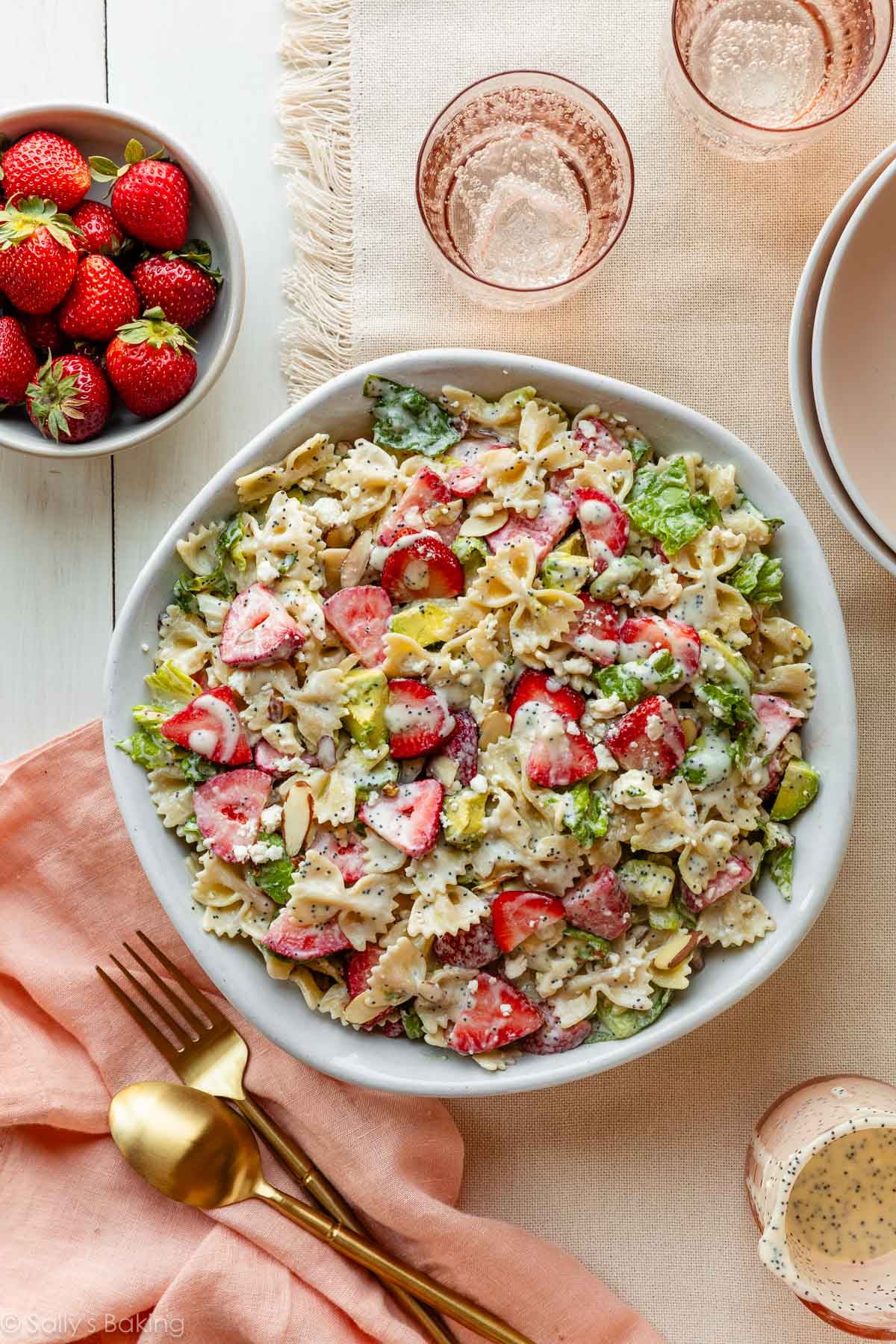 strawberry feta pasta salad with poppy seed dressing on top.