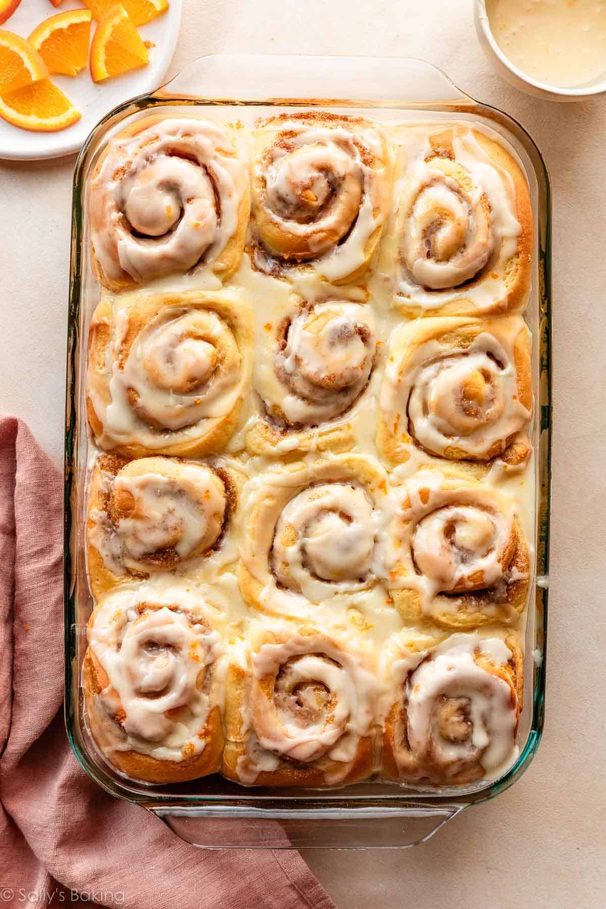 orange sweet rolls in glass baking dish.