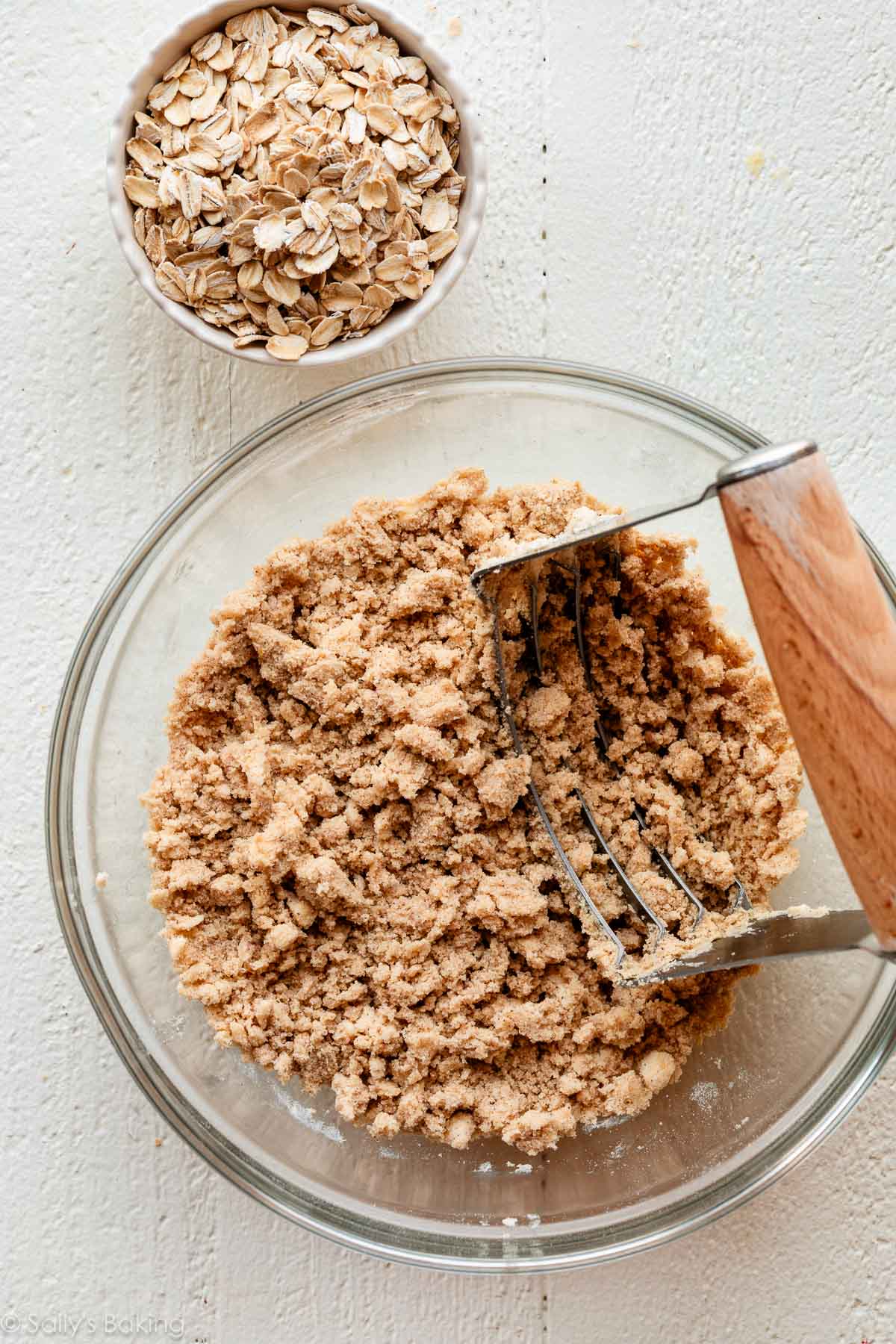 crumble topping in bowl with pastry cutter.