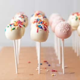 cake pops with white coating and light pink coating.