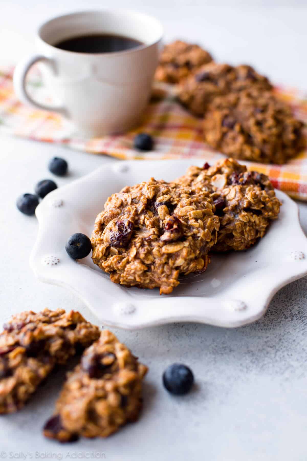 breakfast cookies on a white plate with a cup of coffee