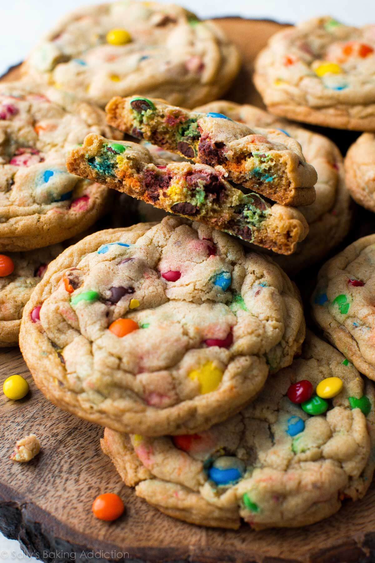 M&M cookies on a wood slice serving plate