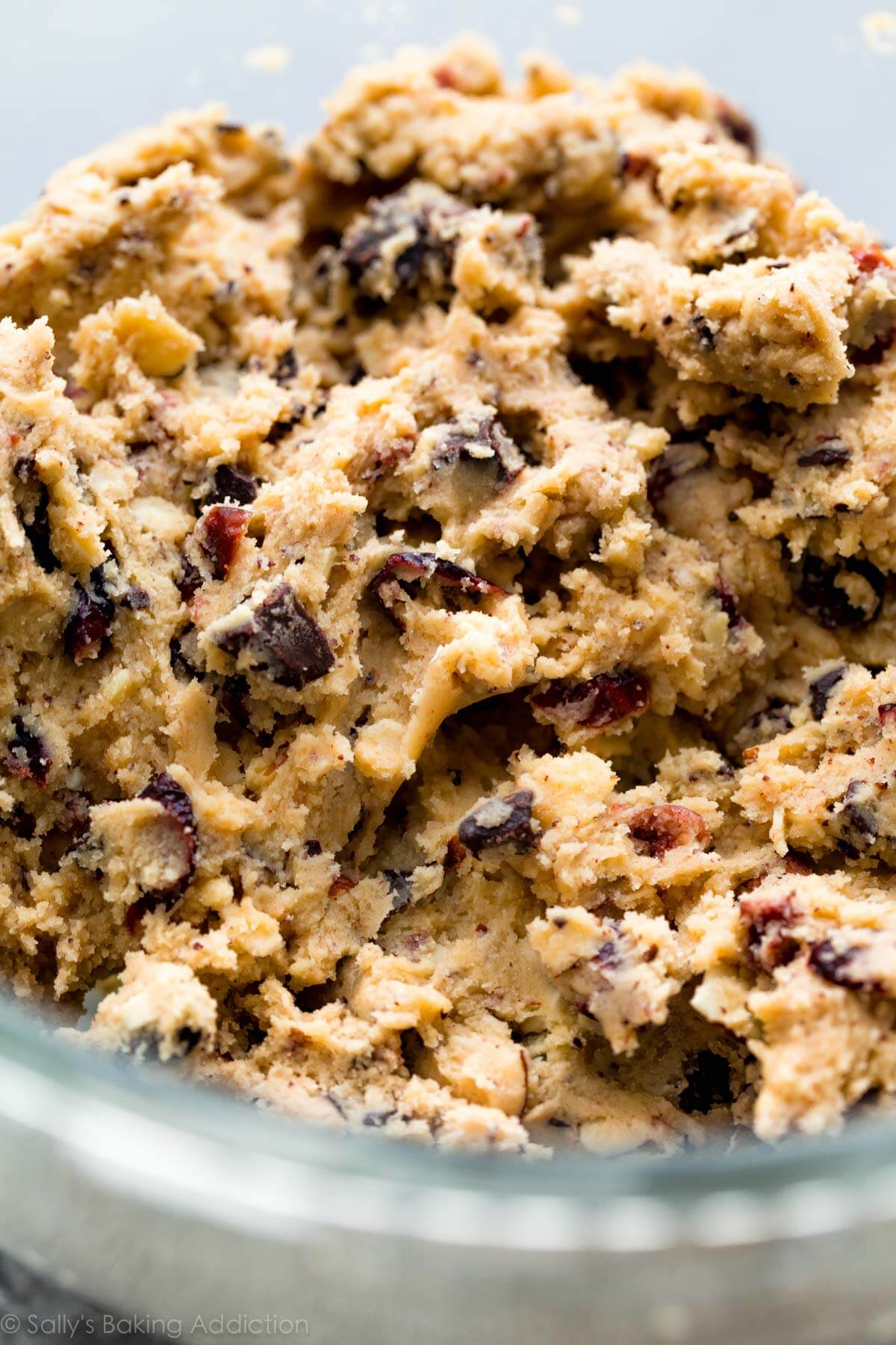 dark chocolate cranberry almond cookie dough in a glass bowl