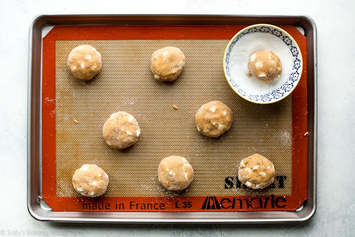 white chocolate peanut butter cookie dough balls on a baking sheet
