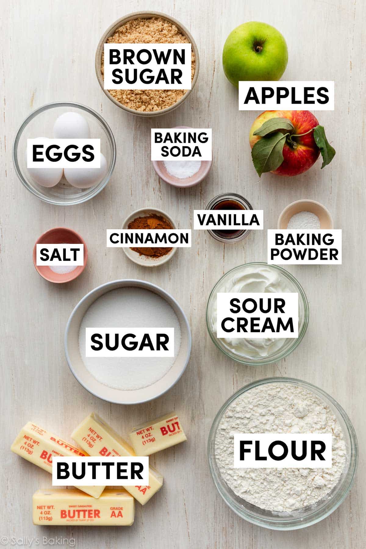 ingredients measured in bowls including flour, sour cream, sugar, cinnamon, and eggs.
