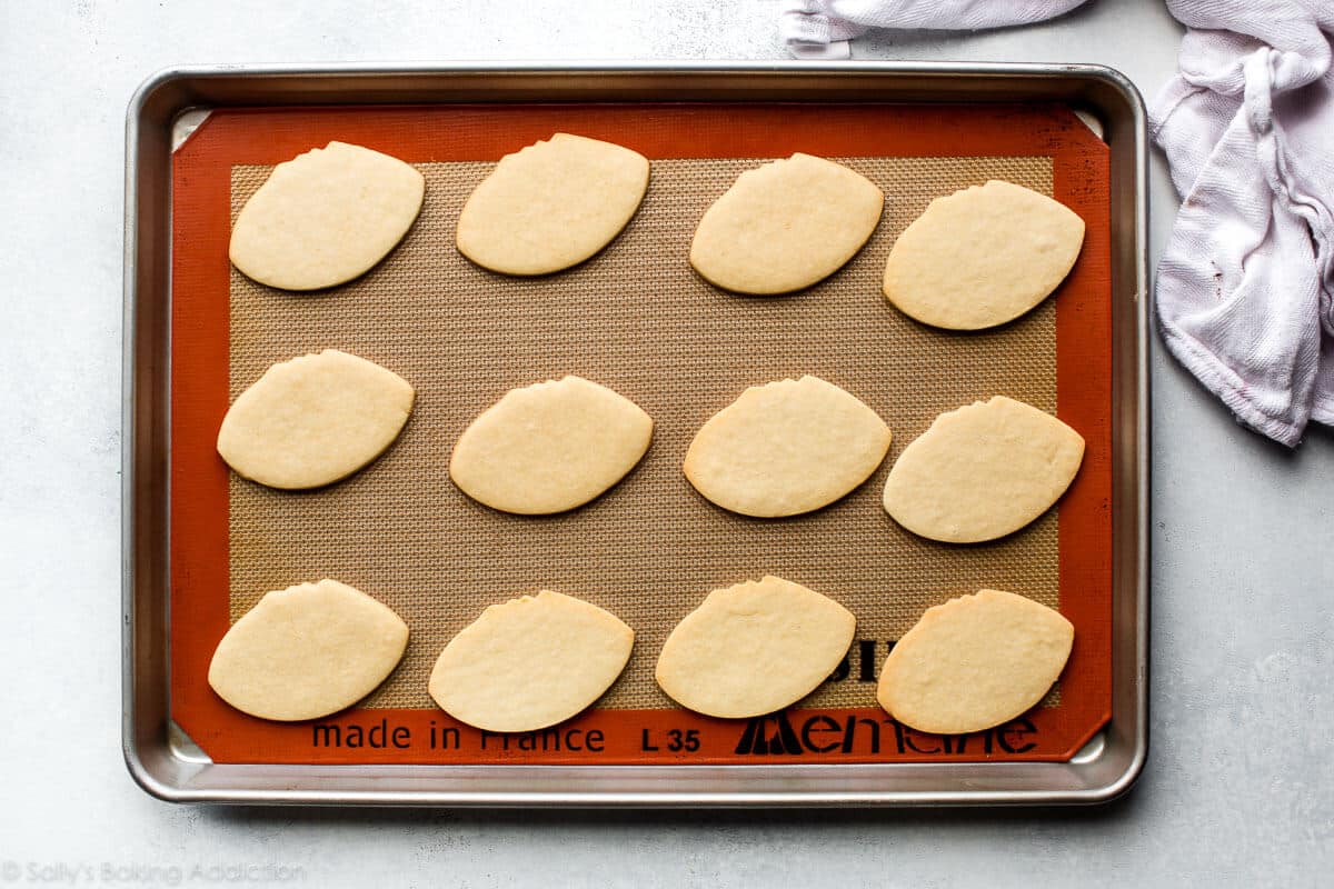 football shaped sugar cookies on a baking sheet
