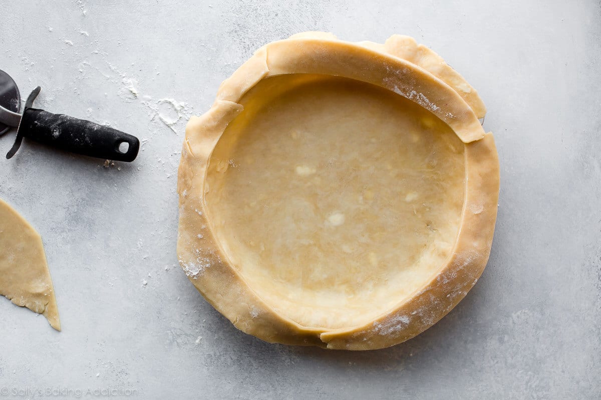pie dough in a pie dish before baking