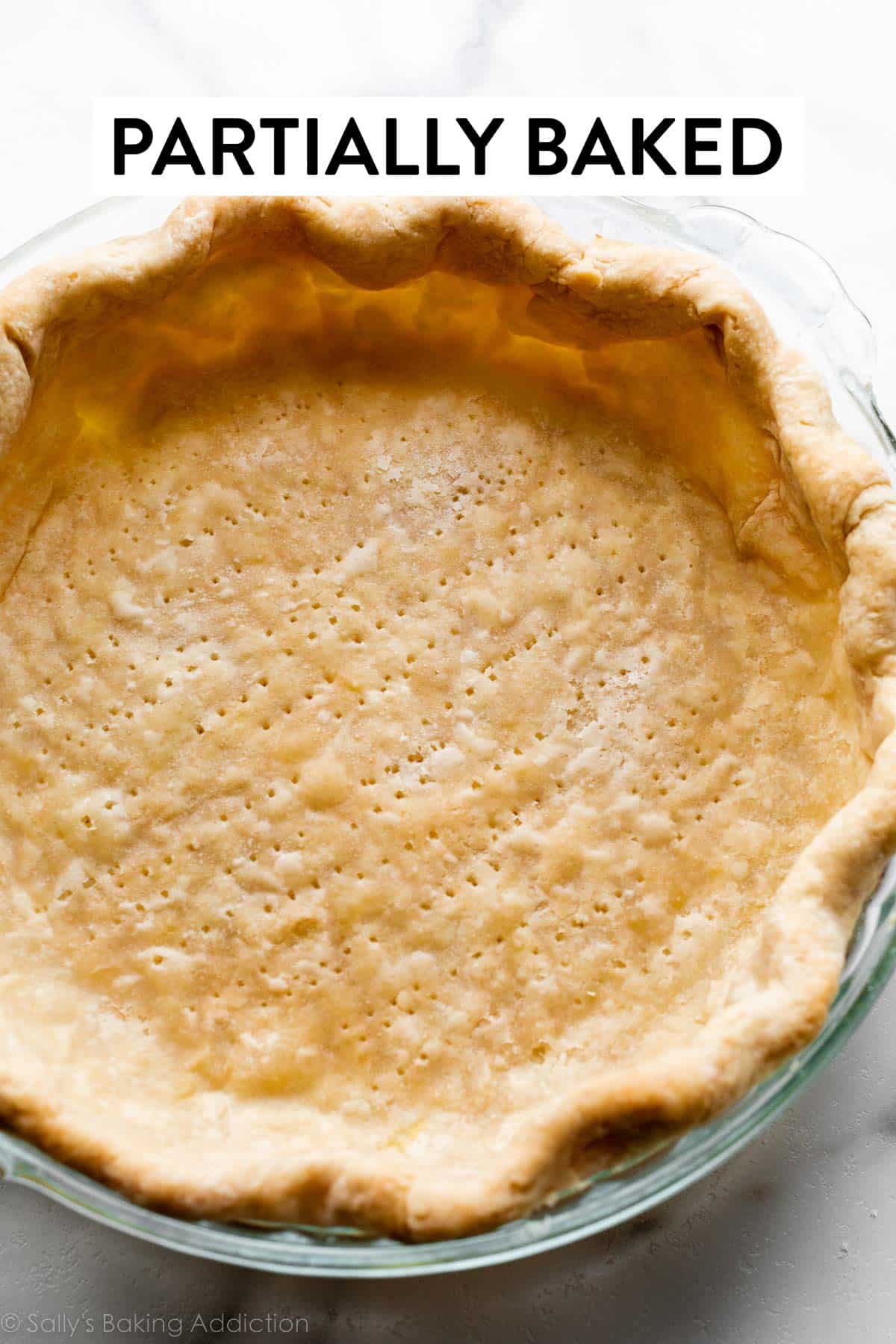 par-baked pie crust shell in glass pie dish.