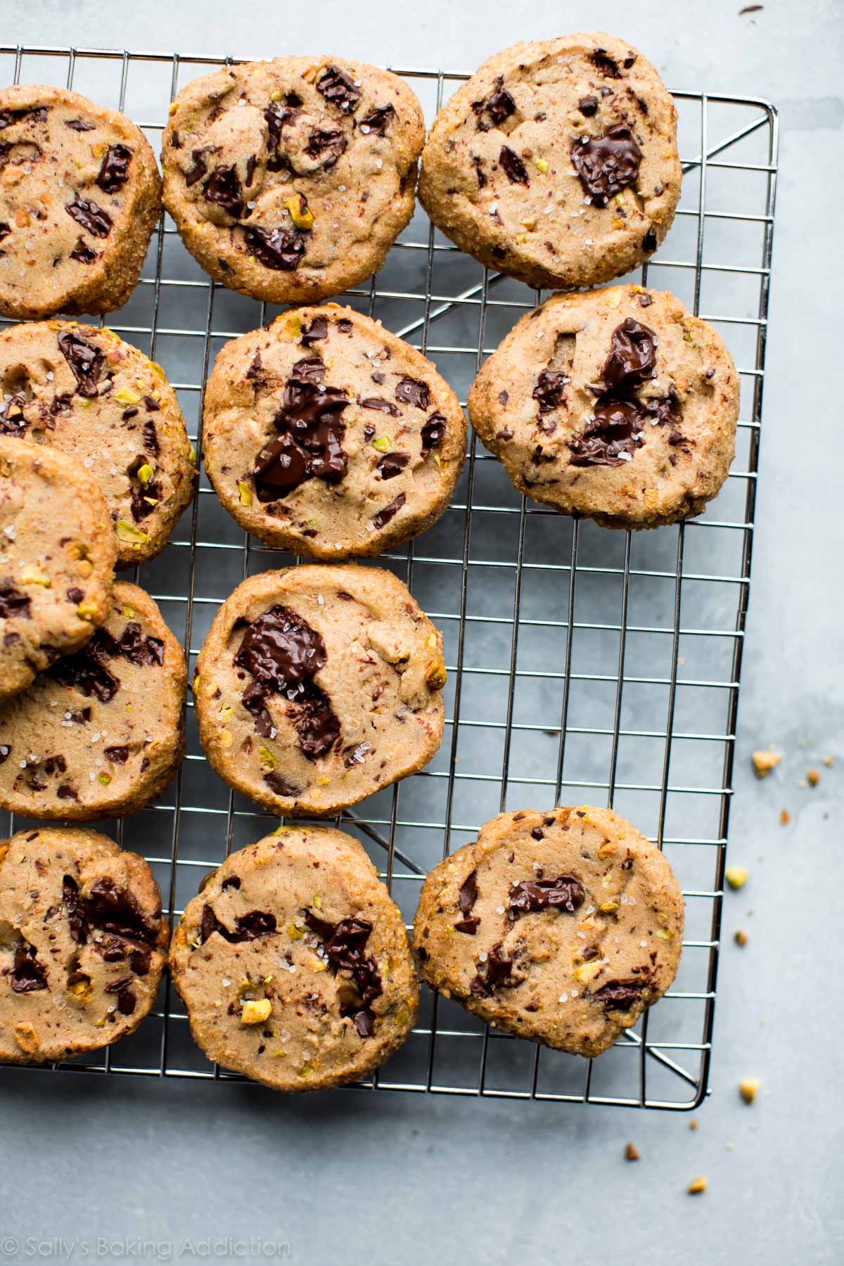 pistachio chocolate chunk cookies on a cooling rack