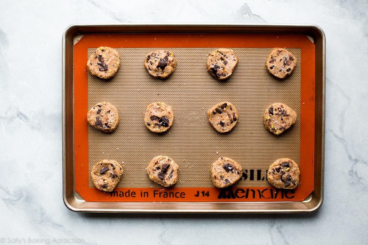 pistachio chocolate chunk cookies on a baking sheet