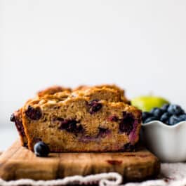 healthy apple blueberry bread on a wood serving tray