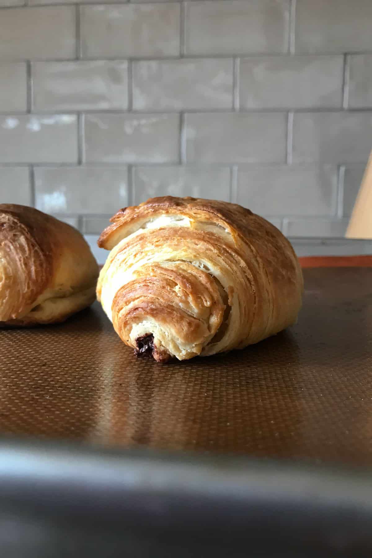 chocolate croissant on baking sheet after baking