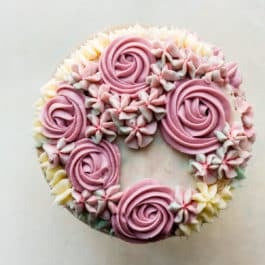 Buttercream roses and hydrangeas on top of 6 inch cake