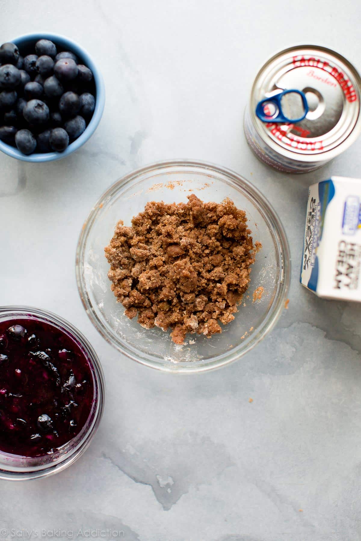 graham cracker crumbles and blueberry sauce in bowls