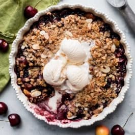 bourbon cherry crisp with ice cream on top