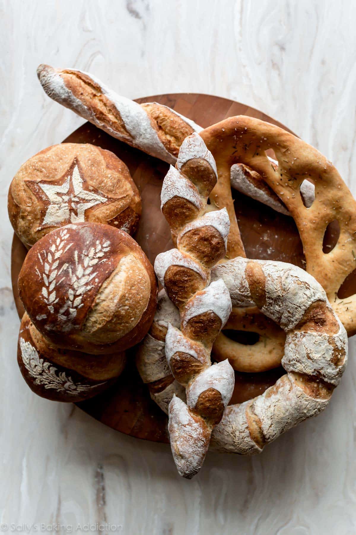 overhead image of various breads on a wood serving tray