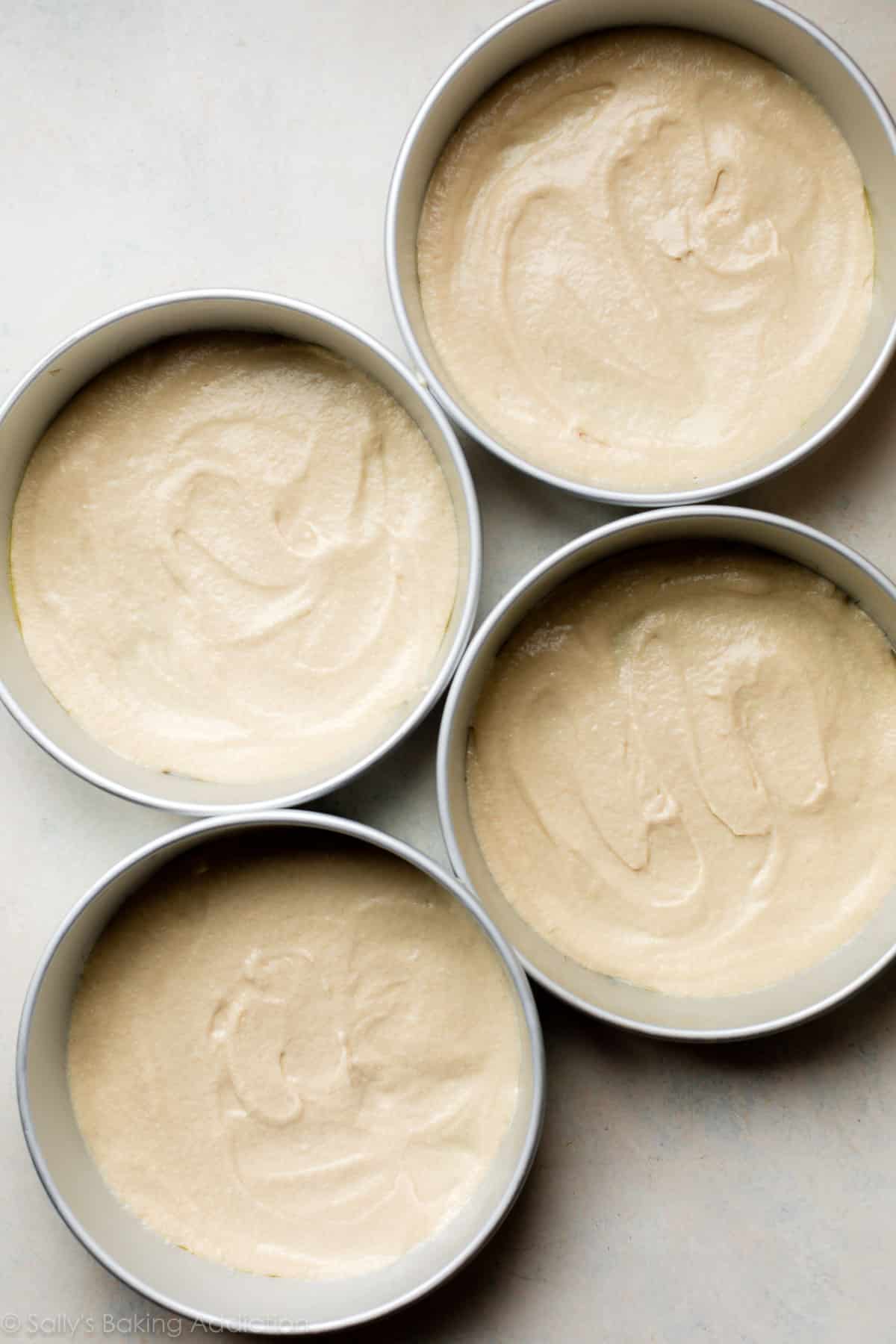 Smith Island cake batter in round baking pans before baking