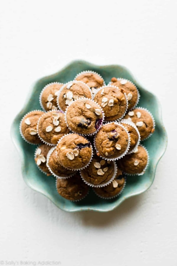 overhead image of baby muffins stacked on a teal plate