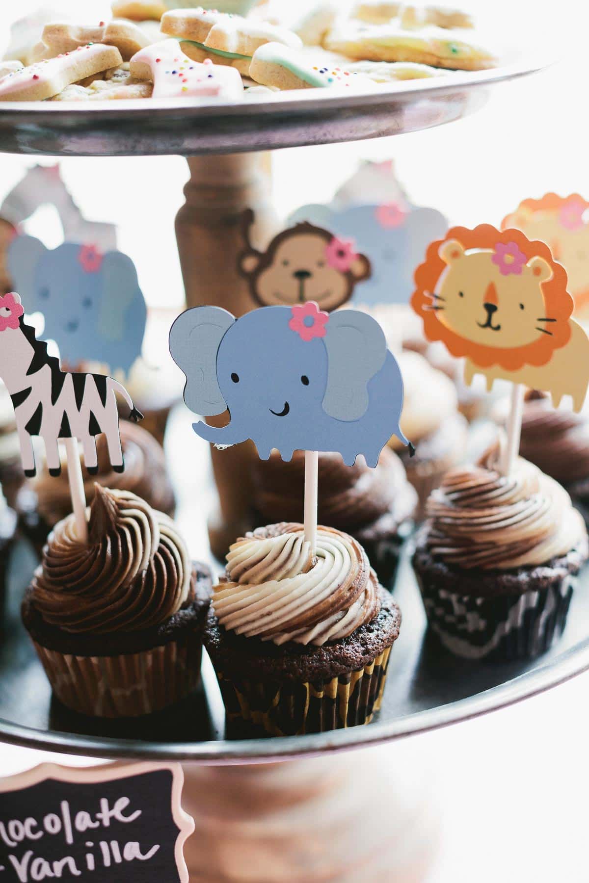 dessert stand with cupcakes and animal cracker cookies