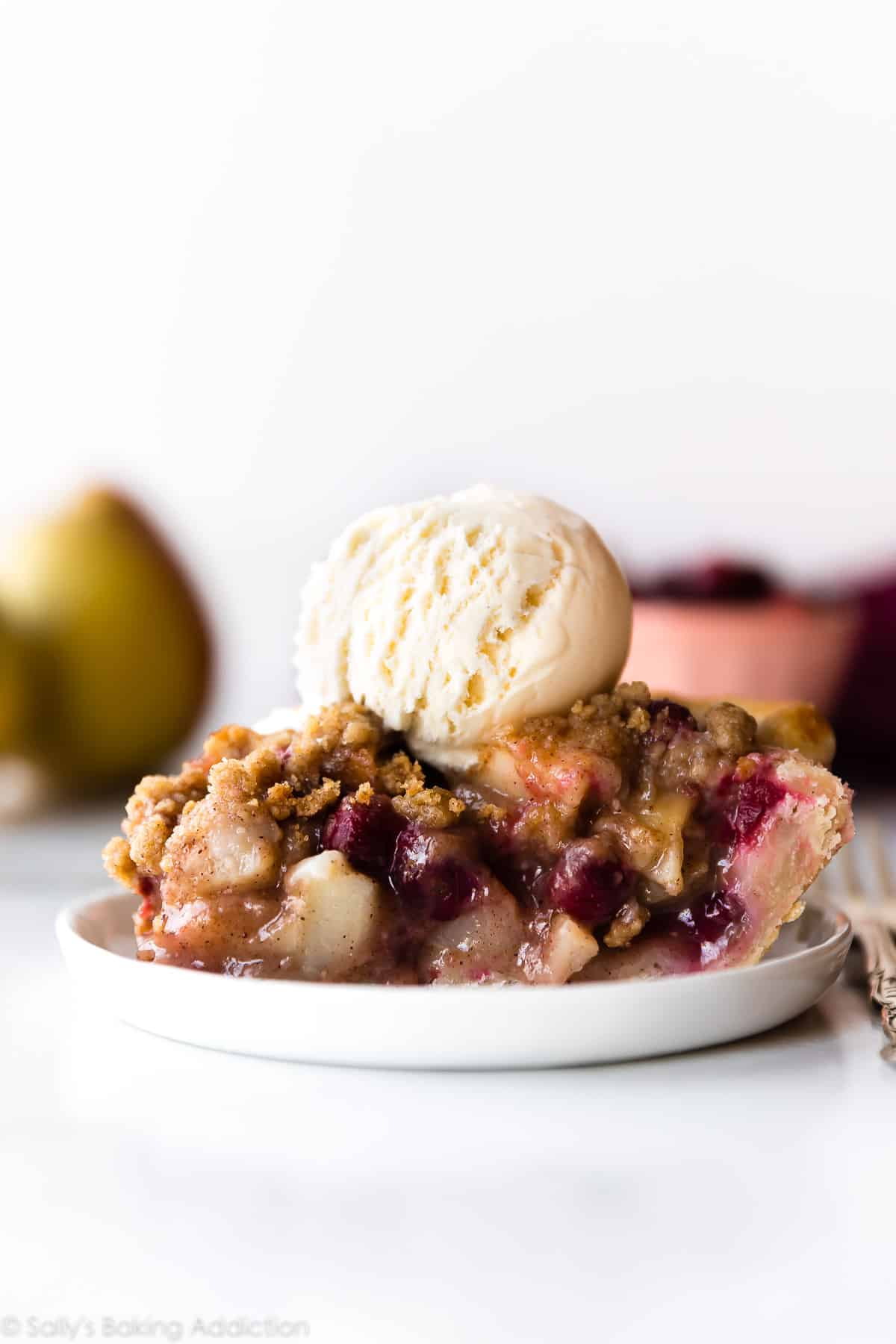 slice of cranberry pear crumble pie on a white plate