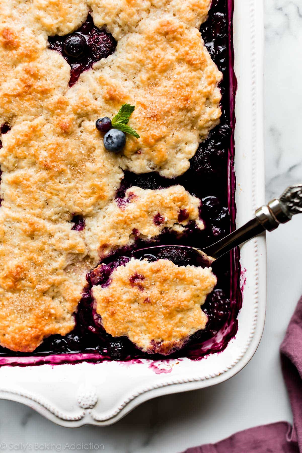 mixed berry cobbler in 9x13 inch white baking dish