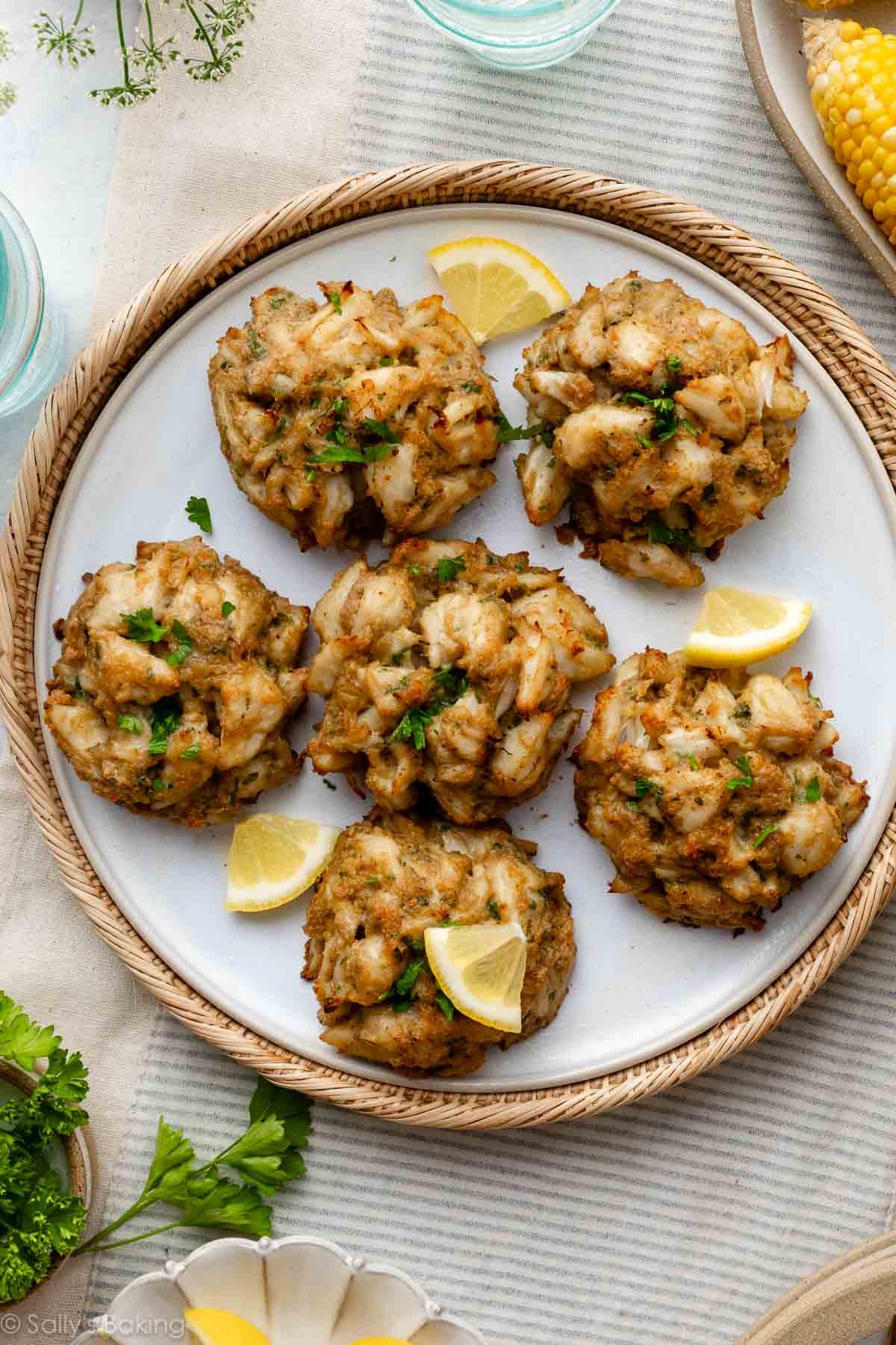 6 homemade crab cakes on platter.