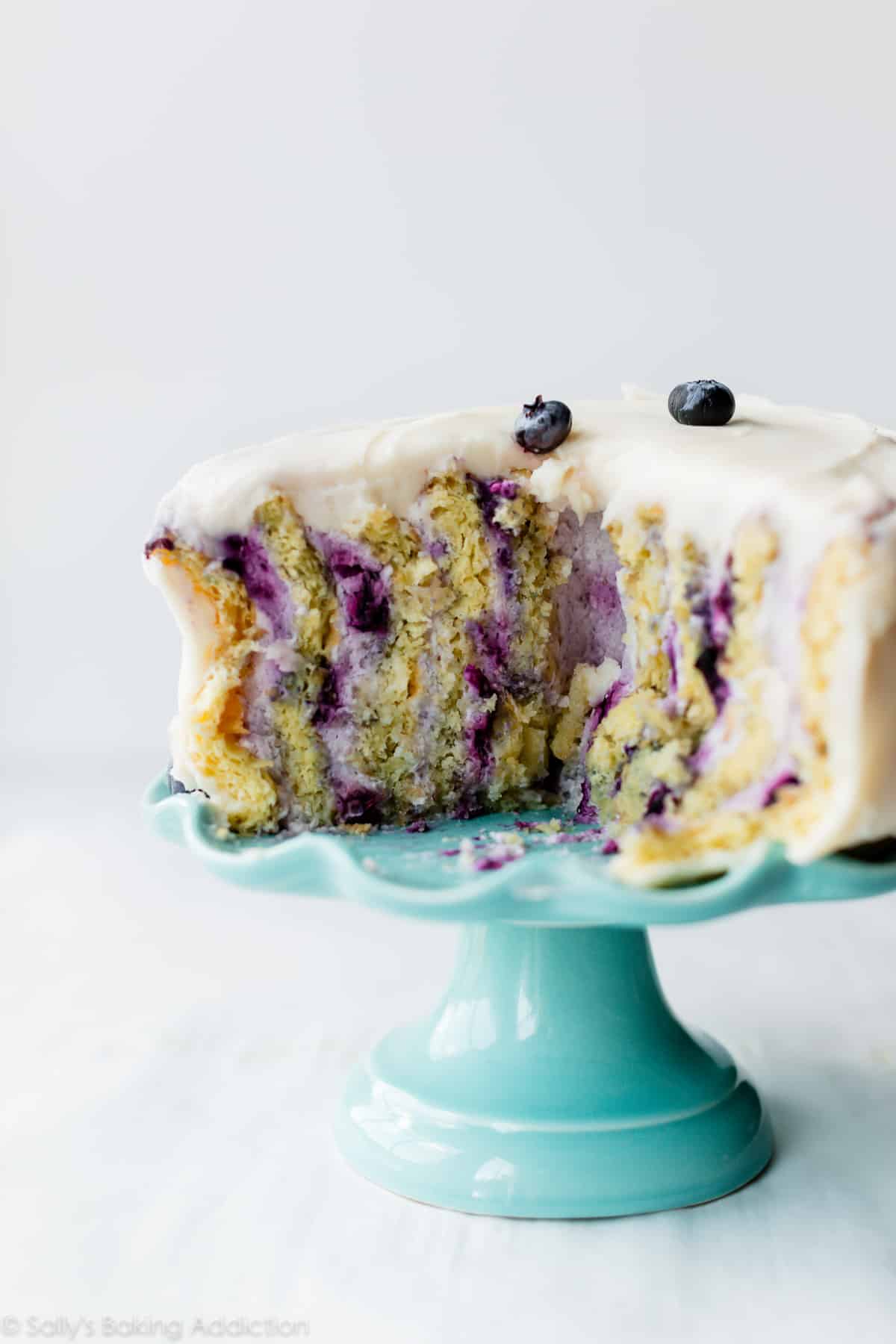 squished vertical cake on blue cake stand