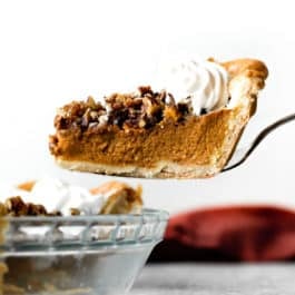 slice of pecan praline pumpkin pie on a pie server