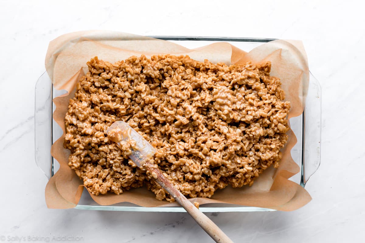 spreading scotcheroos mixture into pan