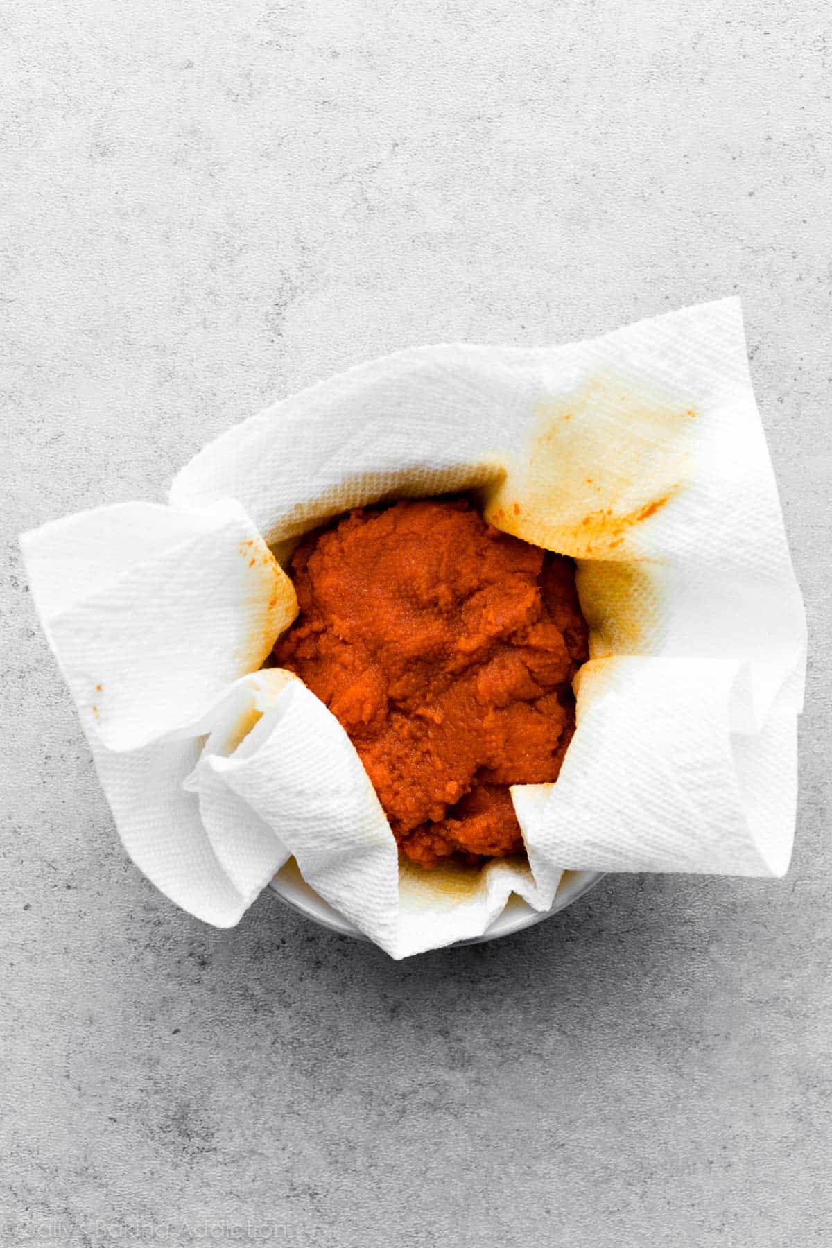 blotting pumpkin with a paper towel