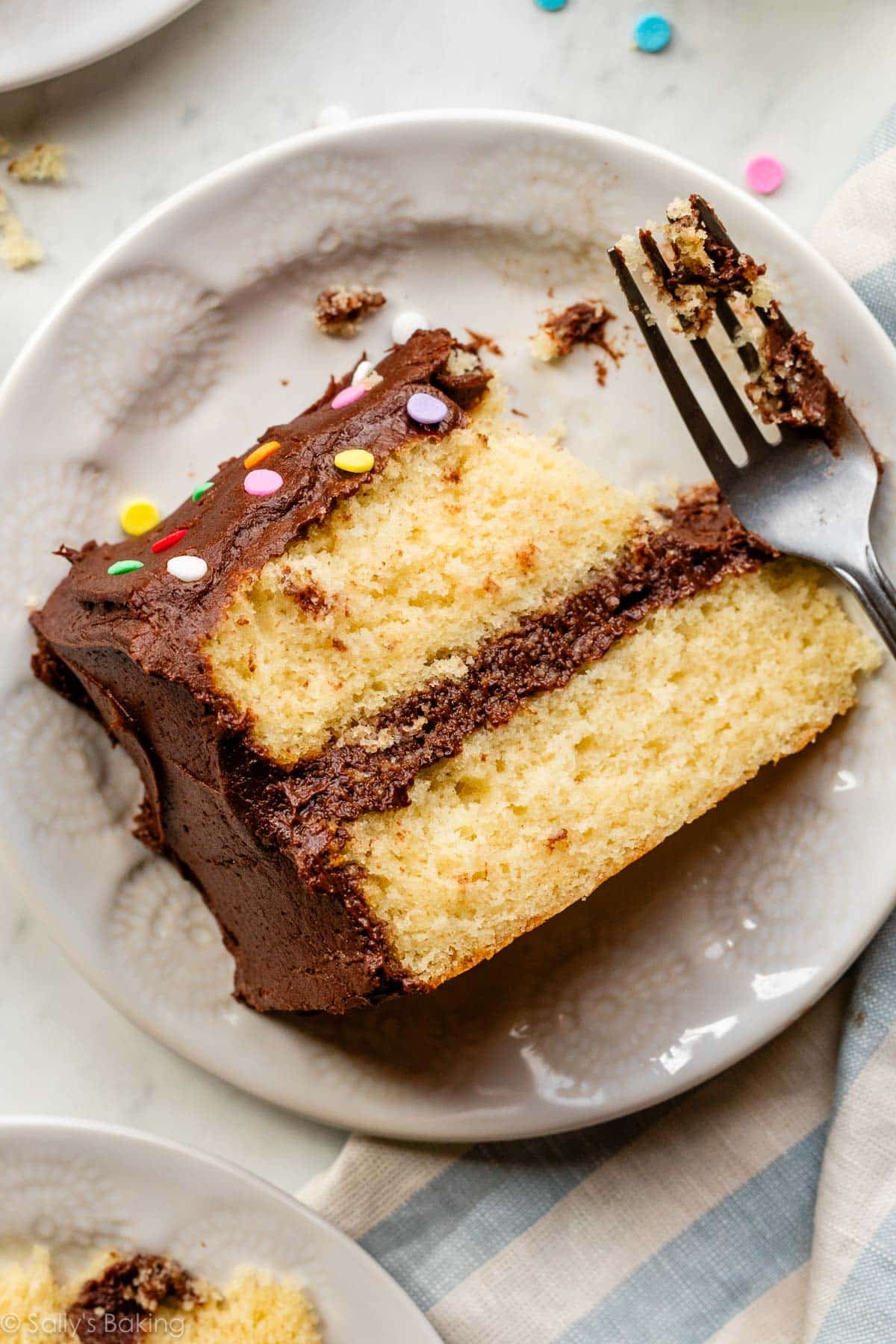 yellow cake slice on white plate.