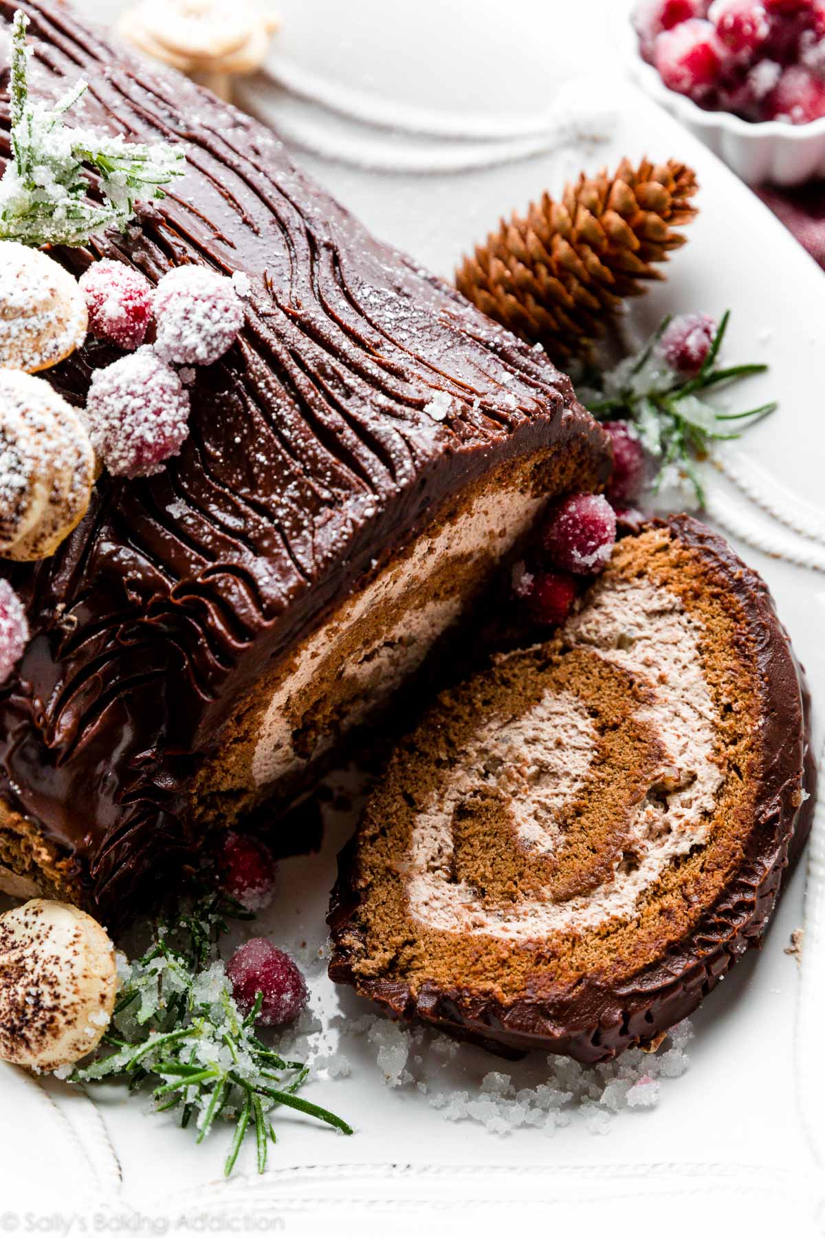 sliced yule log with chocolate ganache and meringue mushrooms