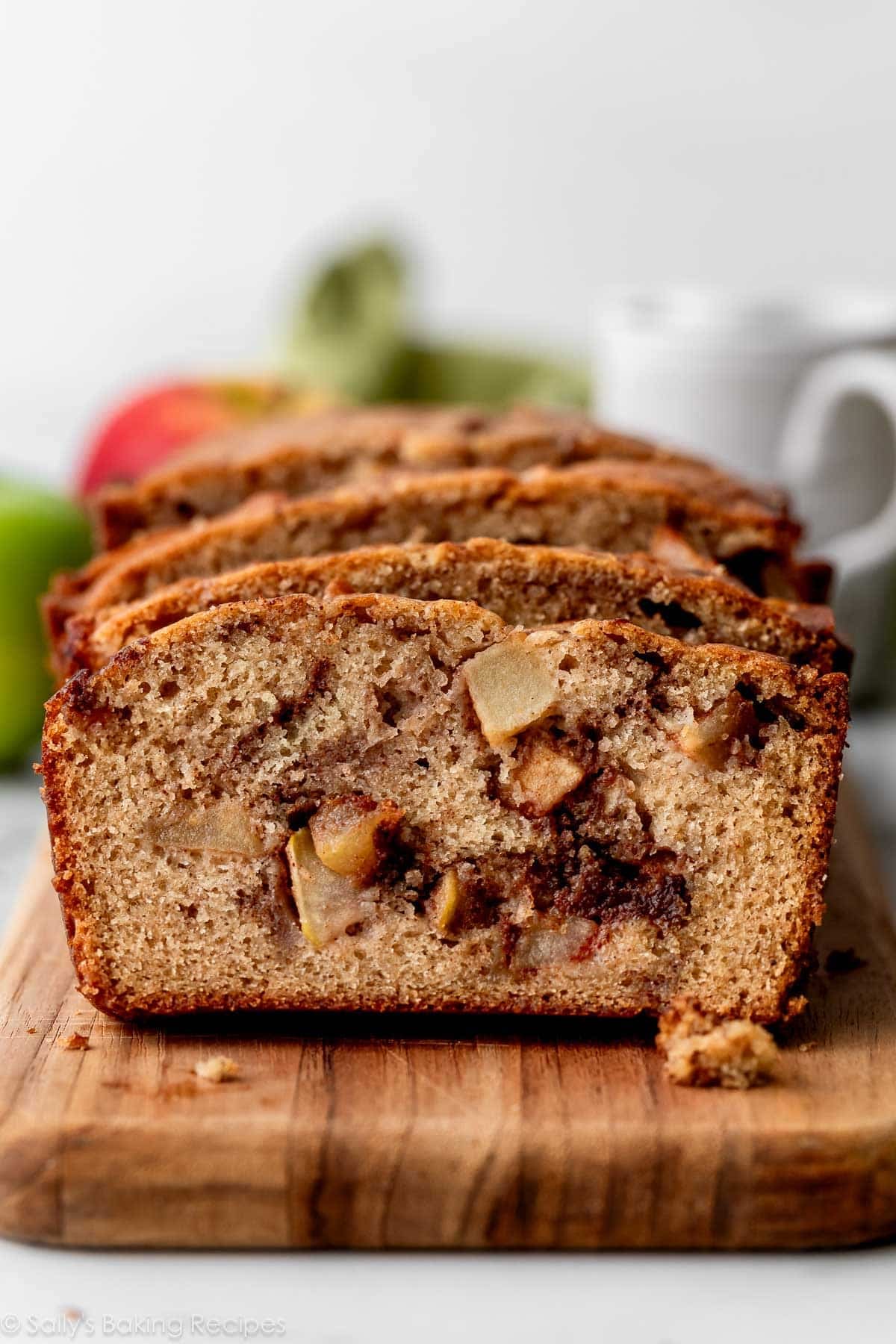 slices of apple cinnamon bread on wooden cutting board.
