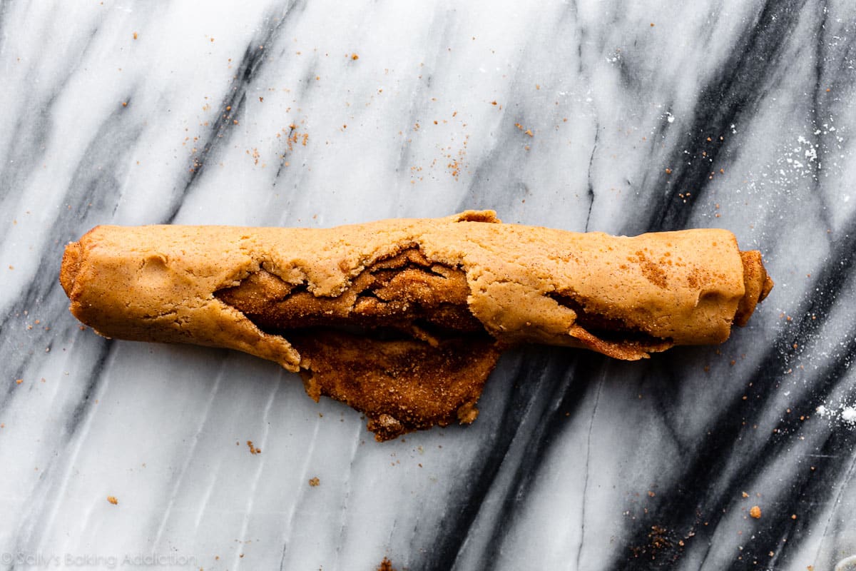 rolled up pumpkin dough that has cracked and fallen apart