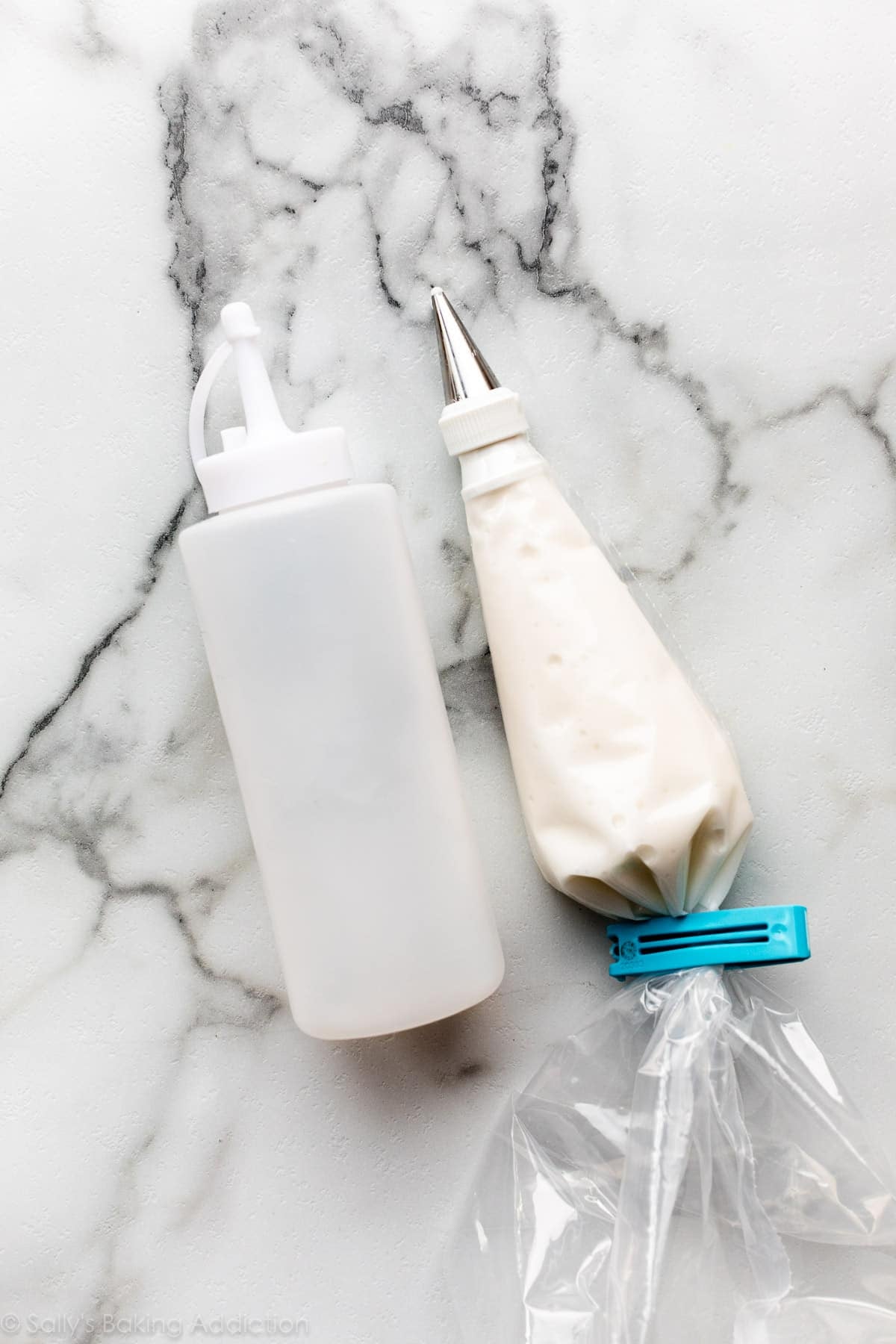 squeeze bottle and piping bag filled with white icing