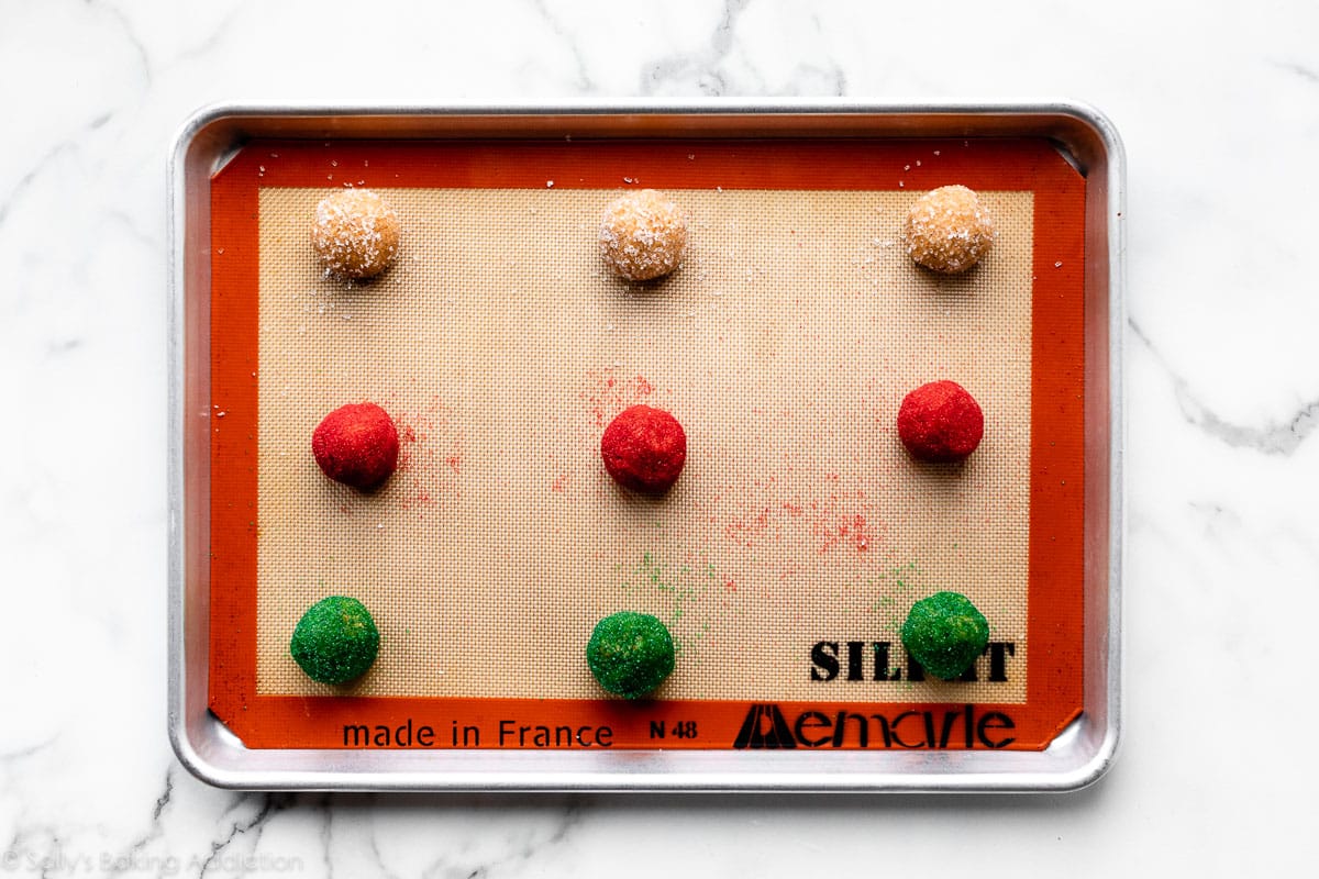 almond butter cookie dough balls on lined baking sheet