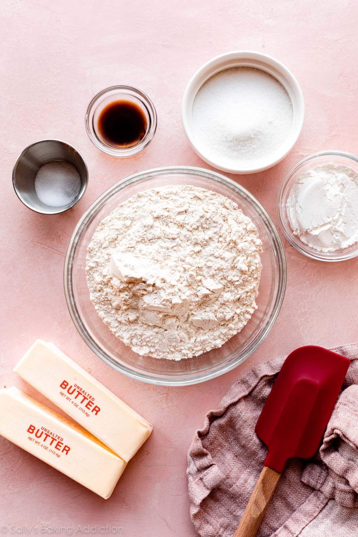 2 sticks of butter and ingredients in bowls including flour, vanilla, salt, cornstarch, and sugar