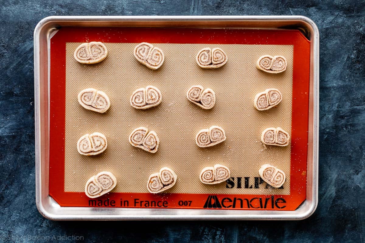 cinnamon and spice palmiers or elephant ear cookies on baking sheet