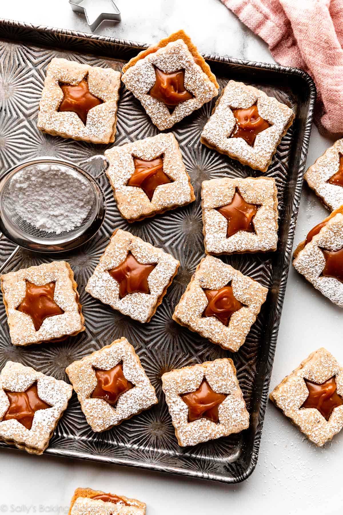 caramel hazelnut sandwich linzer cookies on baking sheet