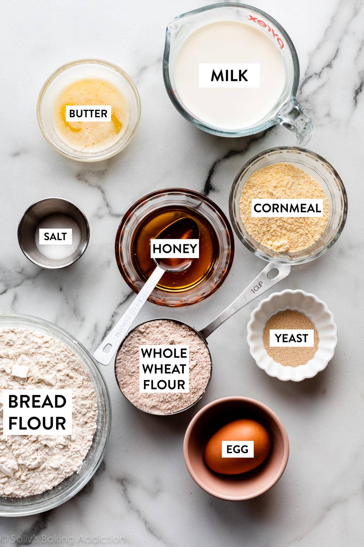 ingredients needed for dough including egg, melted butter, whole wheat flour, honey, milk, and yeast