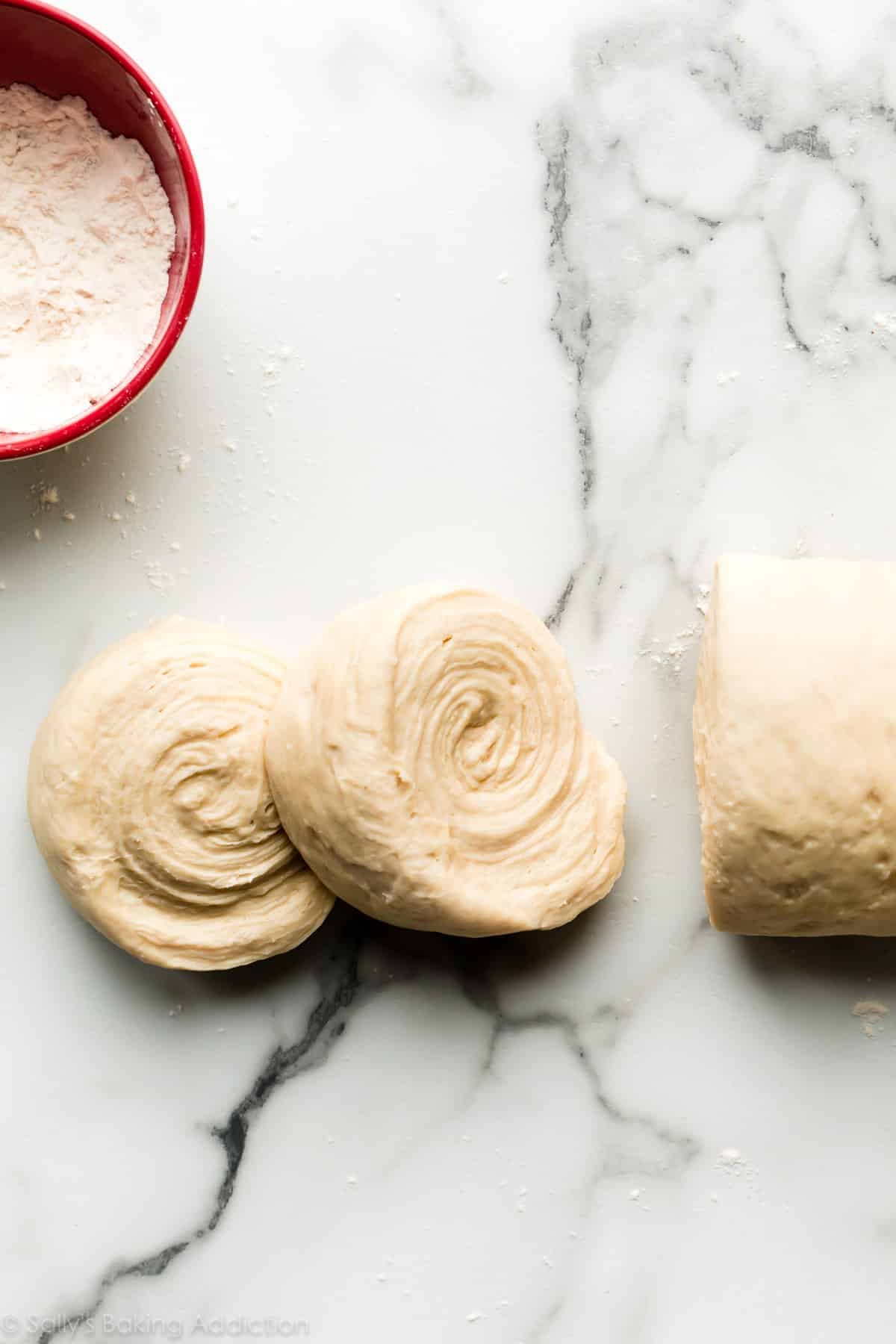laminated croissant dough rolled up and sliced