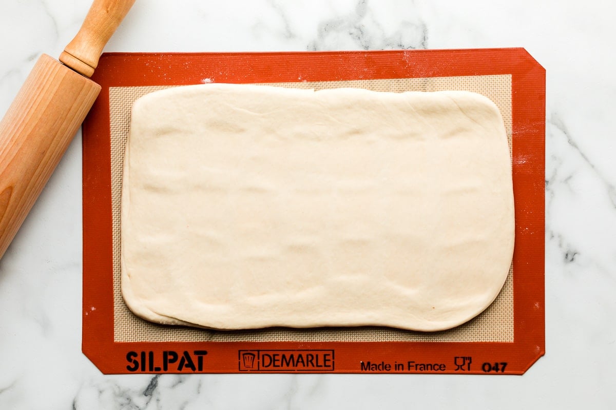 rolled out laminated dough on lined baking sheet